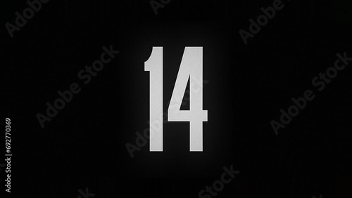 The number 14 burns down and turns into ashes on a black background photo