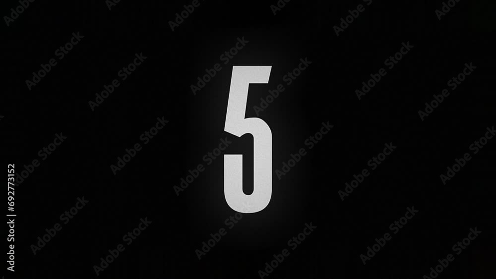 The number 5 burns and turns into ashes on a black background The number 5 burns and turns into ashes on a black background