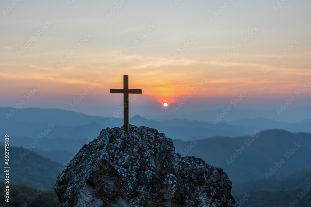 Silhouettes Crucifixion cross on top mountain with sunset background.religion and christianity concept - obrazy, fototapety, plakaty 