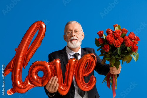 Smiling senior man holding ...