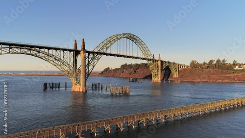 Aerial Drone Video- Yaquina Bay Bridge Sunrise- Newport Oregon- Slow dolly-in shot over fishing pier - no boats V04 photo