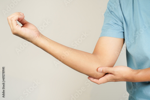 Health concept, person with elbow pain, man holding hand on elbow with pain, bone arthritis