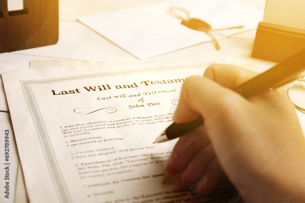 Obraz premium Woman reading Last Will and Testament at table, closeup