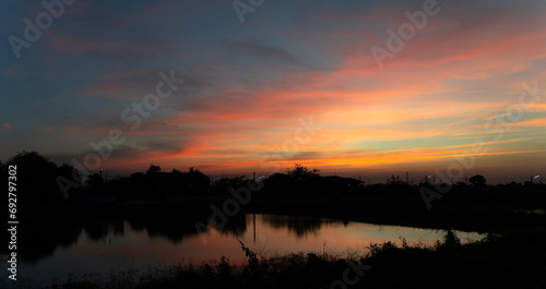 Twilight in the Evening with Orange Gold Sunset, Real amazing panoramic sunrise or sunset sky with gentle colorful clouds. Nature background, Sky background.
