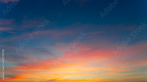 Twilight in the Evening with Orange Gold Sunset, Real amazing panoramic sunrise or sunset sky with gentle colorful clouds. Nature background, Sky background. © Kenstocker