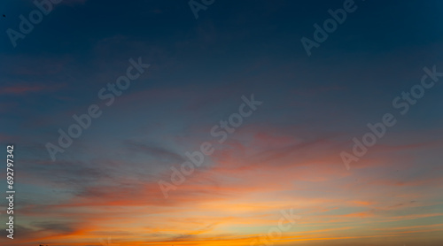 Twilight in the Evening with Orange Gold Sunset, Real amazing panoramic sunrise or sunset sky with gentle colorful clouds. Nature background, Sky background.