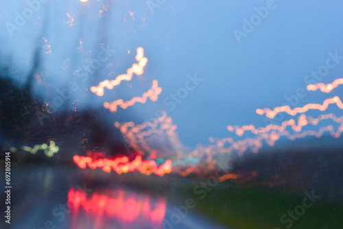 light of car on road in the night, blurred traffic jam background with rain © sutichak