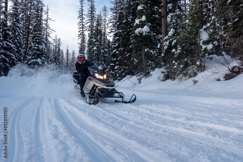 Snowmobile rider in the back country in the mountains of Montana, USA © Allen.G