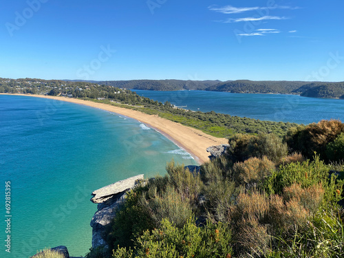 Narrow peninsular is surrounded by water on two sides. Panorama of the ocean. View of the beach and the island's coastline. Palm beach, Australia, NSW. Beach that divides the ocean. photo