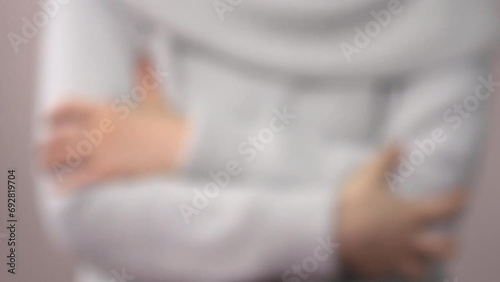 Defocus, closeup shot of a young woman scratching her arms. 4K  Blurred shot of the itchy body with skin problem. photo