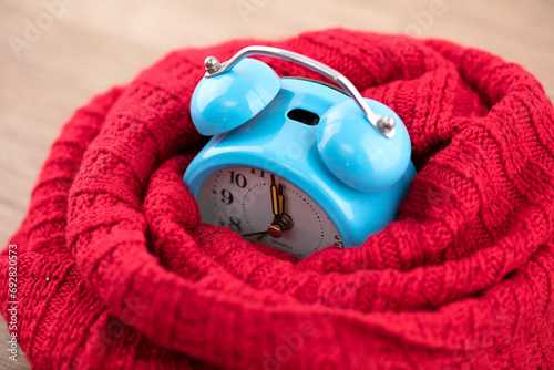 Surrounded by a scarf to keep the alarm clock warm