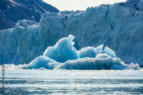 Recently calved from the Monacobreen Glacier in Liefde Fjord, iceberg floating in the arctic ocean around Svalbard, signs of climate change and global warming
 photo