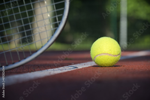 Tennis ball and racquet on hard court surface