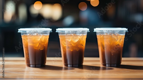 plastic coffee cups cold coffee is placed on a wooden