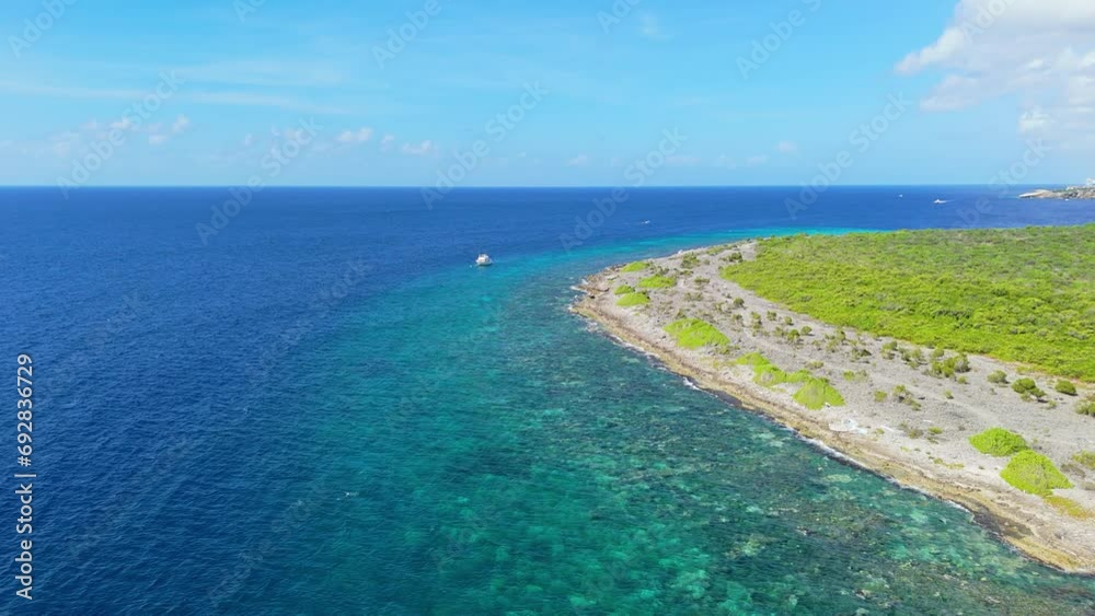 Panoramic aerial overview push in to dive boat anchored near stunning beautiful reef in Curacao Panoramic aerial overview push in to dive boat anchored near stunning beautiful reef in Curacao