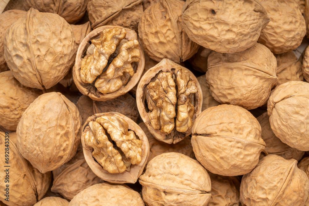 Walnuts in wooden tral on wooden background, Walnuts kernels on wooden table. Walnuts in wooden tral on wooden background, Walnuts kernels on wooden table.