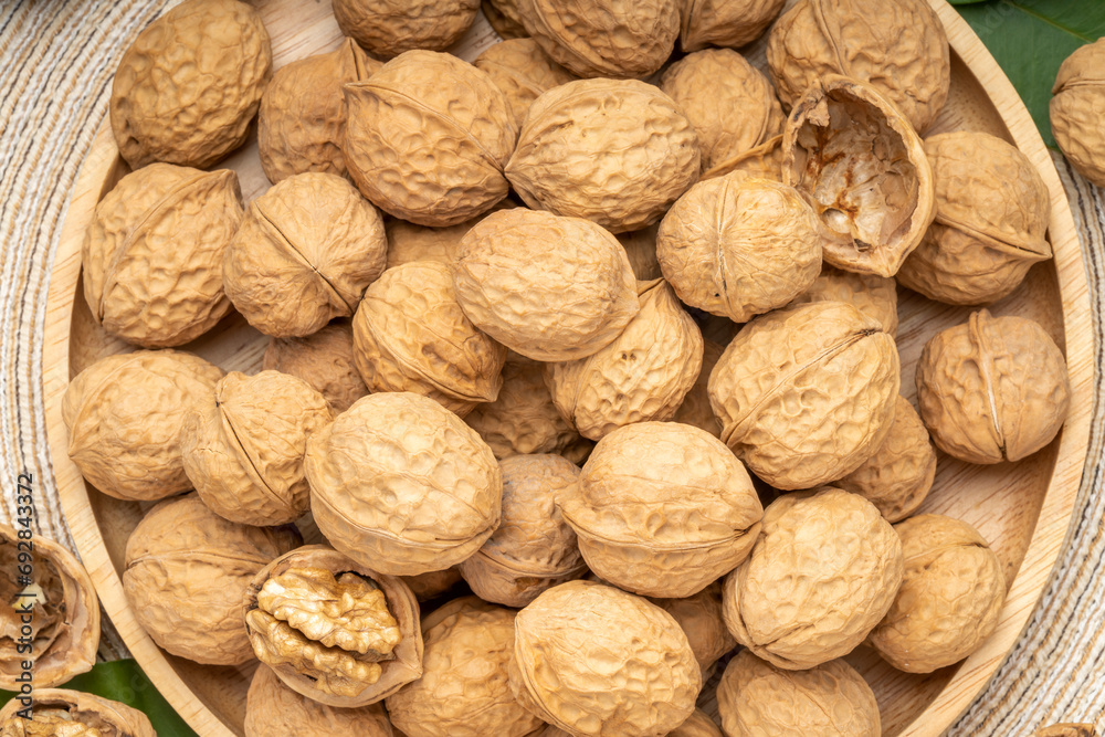 Walnuts in wooden tral on wooden background, Walnuts kernels on wooden table. Walnuts in wooden tral on wooden background, Walnuts kernels on wooden table.