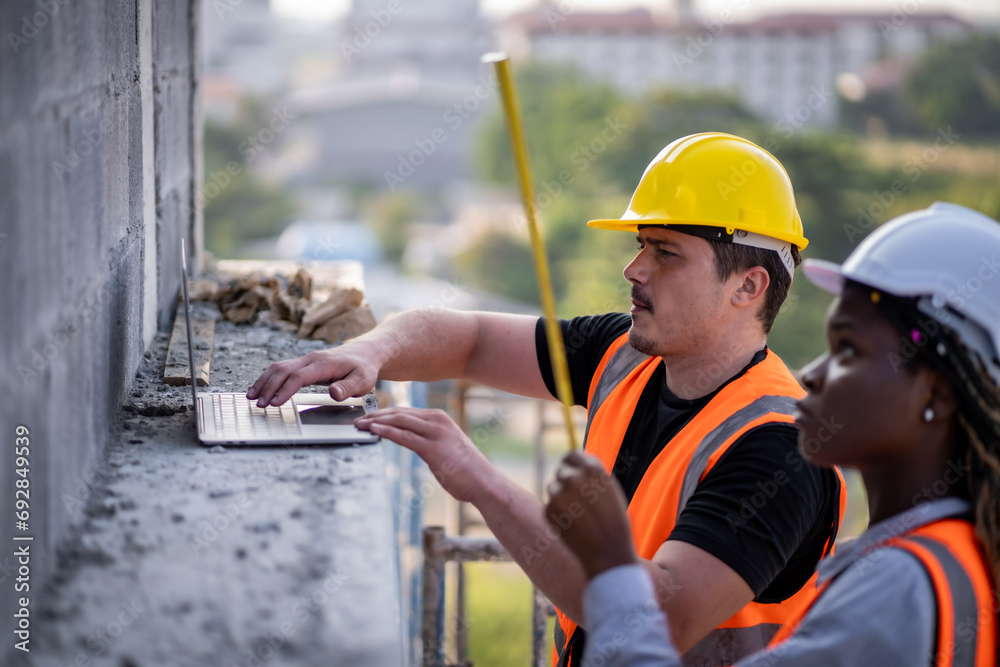 Fototapeta premium Engineer inspect building structure technicians looking at analyzing unfinished construction project