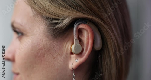 Closeup of woman with hearing aid in ear photo