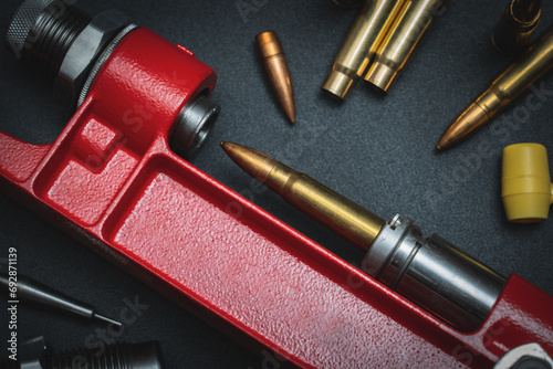 Reloading rifle cartridges, hand press and 7.62x39mm caliber cartridge.  Close-up photo. photo