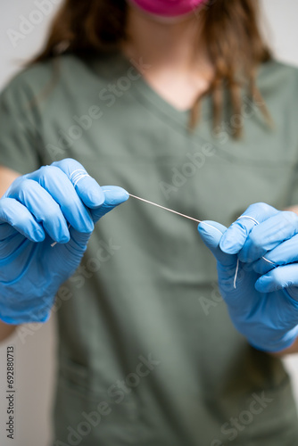 Oral dental floss in dentists hands for teeth cleaning. 