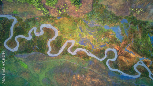 a winding river cutting through lush green land, surrounded by trees, East River, Colorado