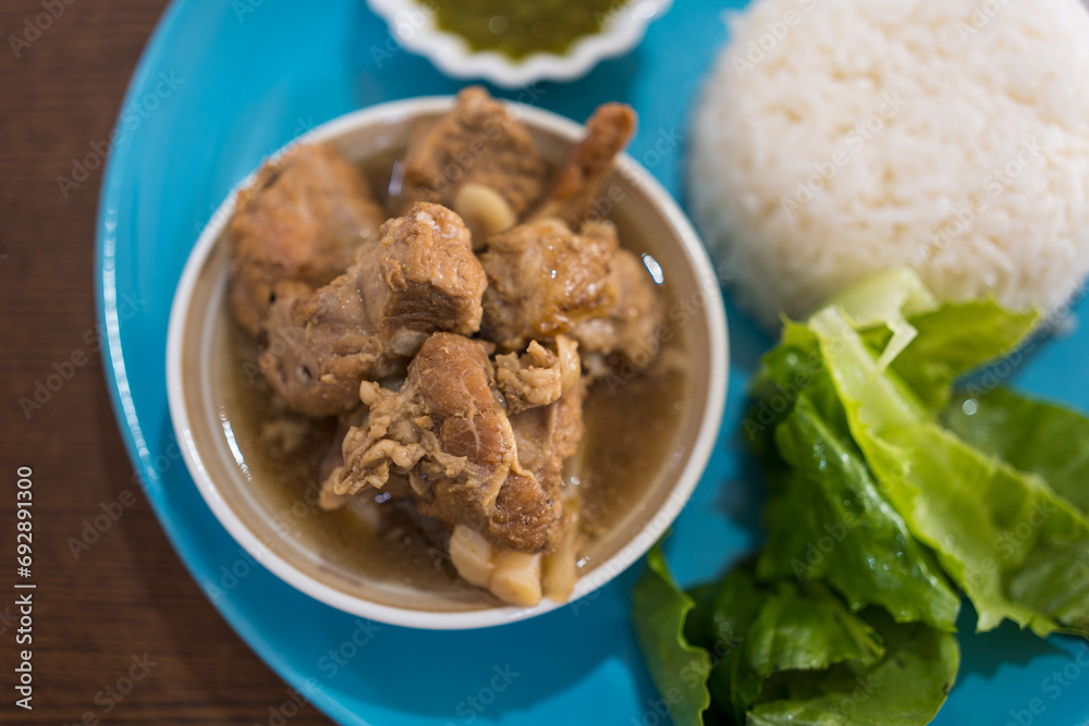 Stewed pork ribs served with rice and vegetable Stewed pork ribs served with rice and vegetable