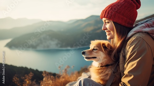 A young woman smiles with her cheerful canine companion, their long hair intertwined as they share a moment of friendship and positive emotion. photo
