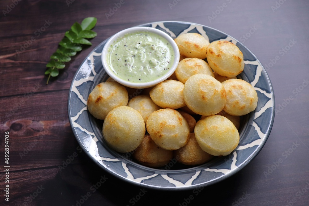 Paniyaram are savory balls made using fermented rice and urad dal batter along with tempered onion and spices. Also known as Paddu, Ponganalu, Kuli, bugga, and appe. served with coconut chutney Paniyaram are savory balls made using fermented rice and urad dal batter along with tempered onion and spices. Also known as Paddu, Ponganalu, Kuli, bugga, and appe. served with coconut chutney