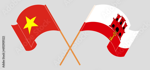 Crossed and waving flags of Vietnam and Gibraltar