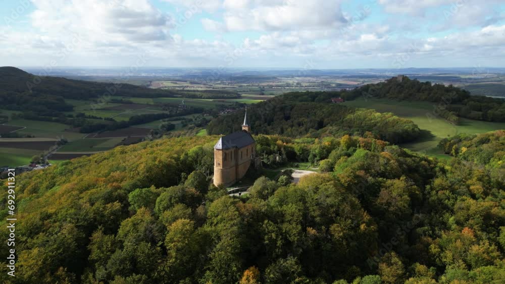 Drone orbiting a chapel in the middle of a forest during daytime Drone orbiting a chapel in the middle of a forest during daytime