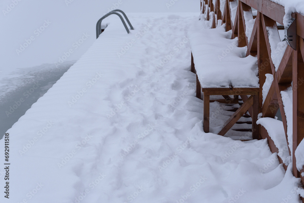 WINTER ATTACK - A frozen lake and a wooden recreation pier covered with snow
WINTER ATTACK - A frozen lake and a wooden recreation pier covered with snow