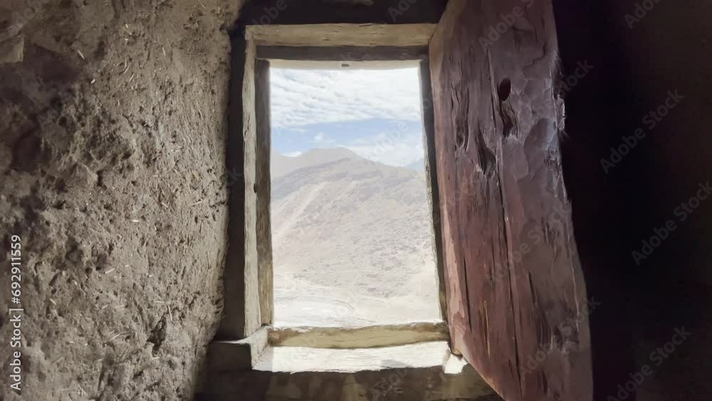 View from wood window frame of Altit fort of Hunza valley in Pakistan View from wood window frame of Altit fort of Hunza valley in Pakistan