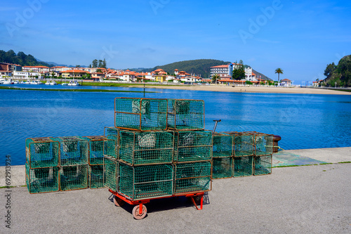 Fishing net with bucket for crayfish and crabs, Green coast of Asturias, Ribadesella village with sandy beaches, North of Spain photo