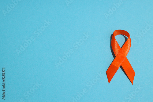 Orange ribbon on a blue background, sclerosis photo