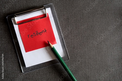 Bilde på lerret Black pencil and red paper note clipping with clipboard on dark copy space backg