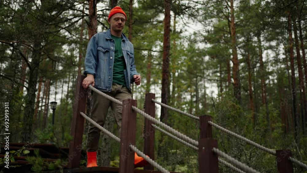 Man Walking Modern Eco Hotel In Forest, Traveler Moving Down On Wooden Stairs In Territory Of Resort Man Walking Modern Eco Hotel In Forest, Traveler Moving Down On Wooden Stairs In Territory Of Resort