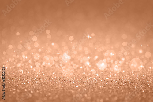 Beige abstract defocused bokeh background. Sparkling texture. Demonstrating color of 2024 year - peach.