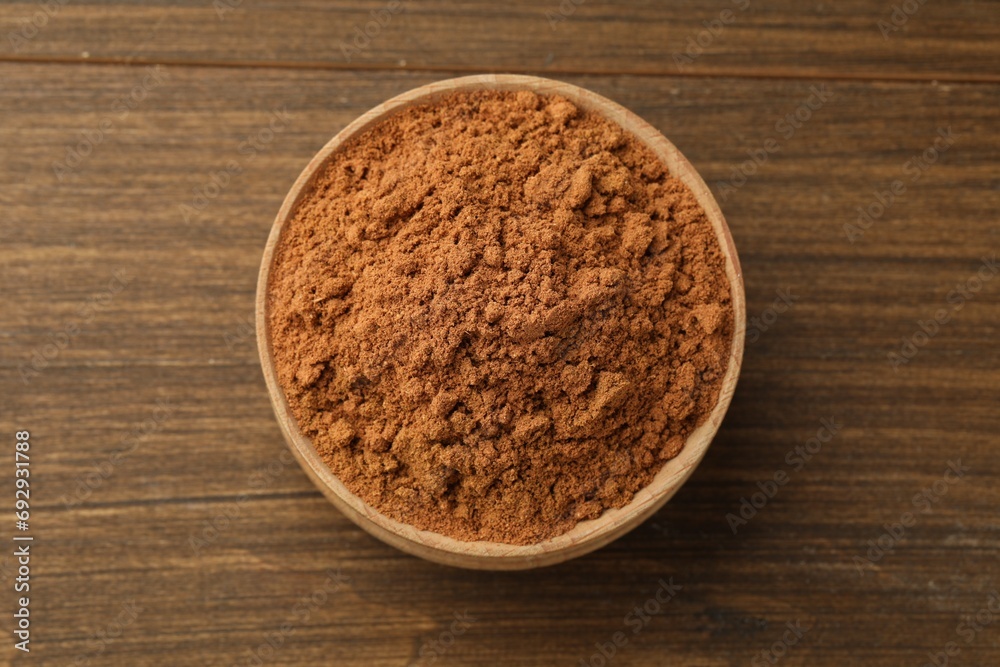 Aromatic cinnamon powder on wooden table, top view Aromatic cinnamon powder on wooden table, top view