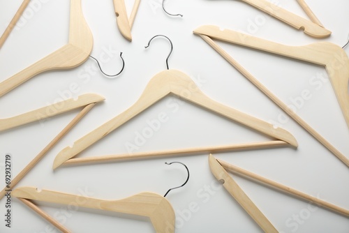 Wooden hangers on white background, flat lay