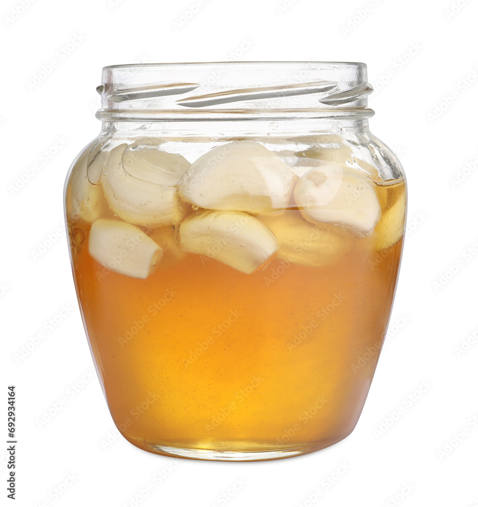 Honey with garlic in glass jar isolated on white Honey with garlic in glass jar isolated on white