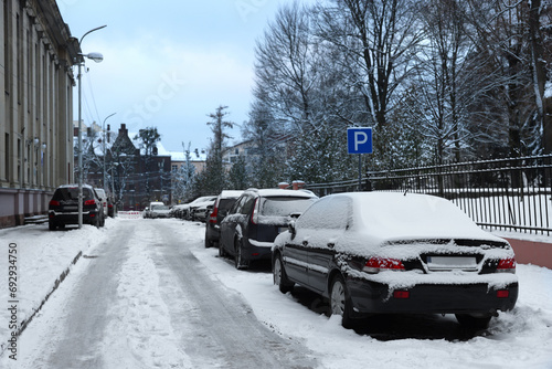 Parked cars on city street in winter
