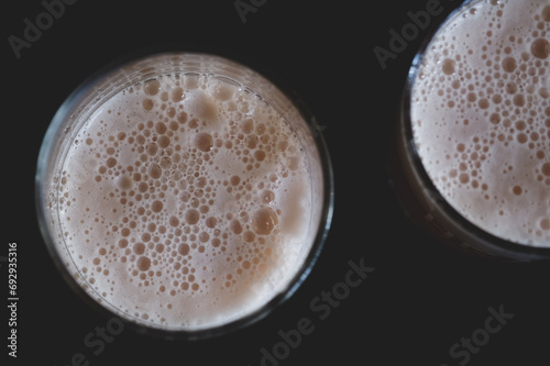 Glass of fresh lager beer with bubble foam, top view
