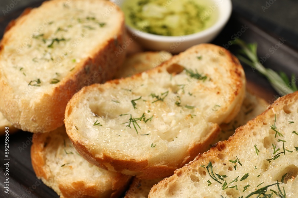 Tasty baguette with garlic and dill, closeup