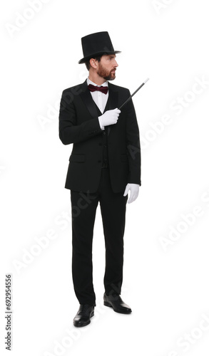 Magician in top hat holding wand on white background