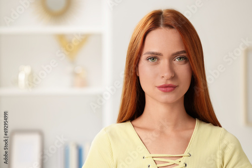 Portrait of beautiful young woman on blurred background, space for text