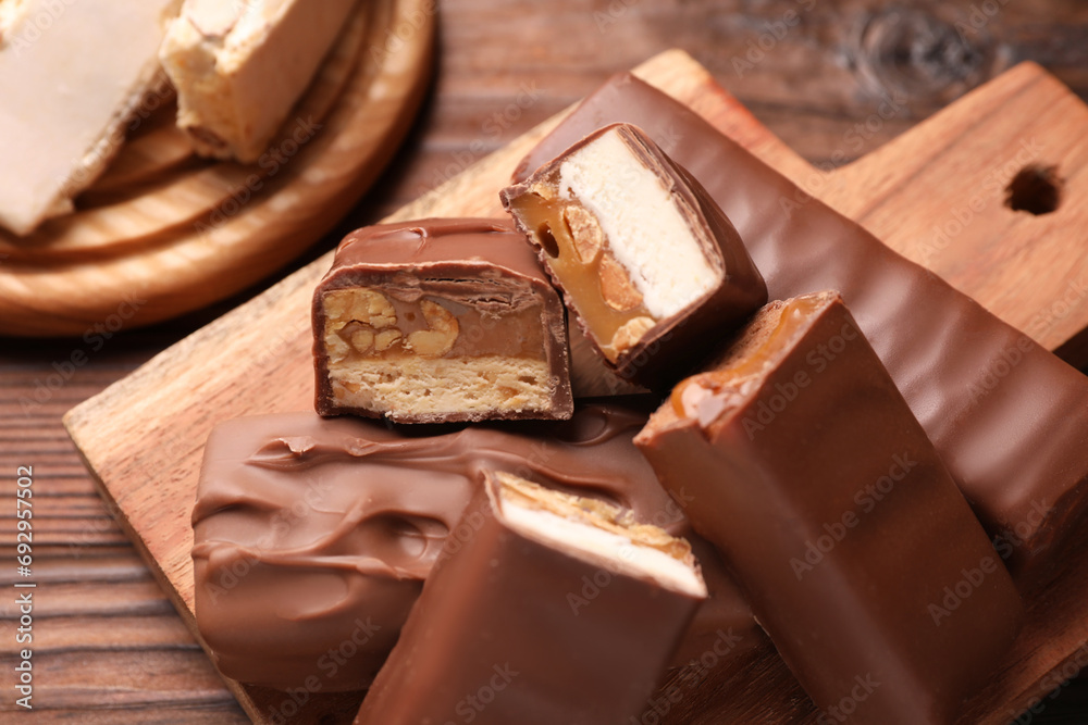 Tasty chocolate bars with nougat on table, closeup Tasty chocolate bars with nougat on table, closeup