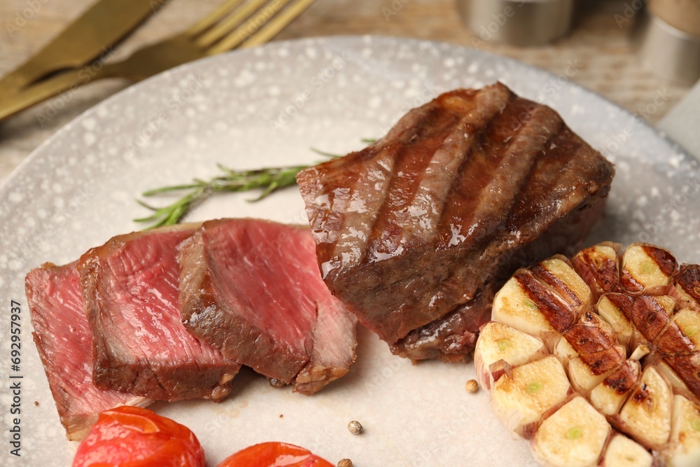 Delicious grilled beef steak with spices on table, closeup Delicious grilled beef steak with spices on table, closeup