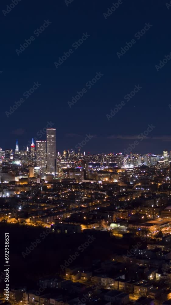 Skyline of New York City at Night. Aerial Hyper Lapse, Time Lapse. United States of America. View from Jersey City. Drone Flies Forward. Vertical Video Skyline of New York City at Night. Aerial Hyper Lapse, Time Lapse. United States of America. View from Jersey City. Drone Flies Forward. Vertical Video