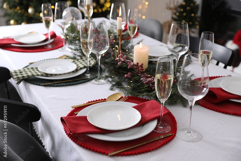Christmas table setting with festive decor and dishware indoors Christmas table setting with festive decor and dishware indoors